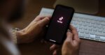 Man uses TikTok app on phone